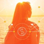 An orange-tinted image of a woman looking out toward the ocean. A yin-yang symbol is at the forefront of the image.