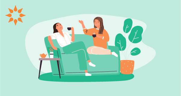 An image of friends discussing red flags in a relationship. The entire background is light teal, and two female friends are sitting on a dark teal couch, chatting over coffee.