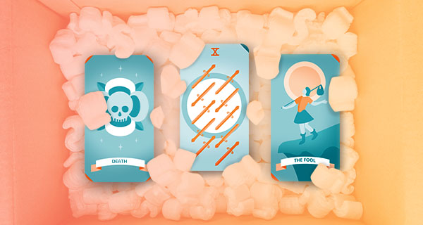 An image showing Tarot cards for moving on, from left to right: Death, the Ten of Swords, and the Fool. The cards are in a moving box full of Styrofoam packing peanuts.