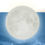 An image of the Full Wolf Moon over a pale blue sky.