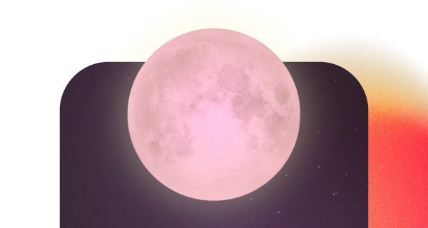 A full pink moon in the night sky, tinted pink.