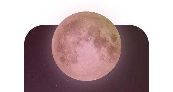 A red-tinted moon rising in the night sky.
