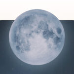 A blue full Sturgeon Moon against the night sky.