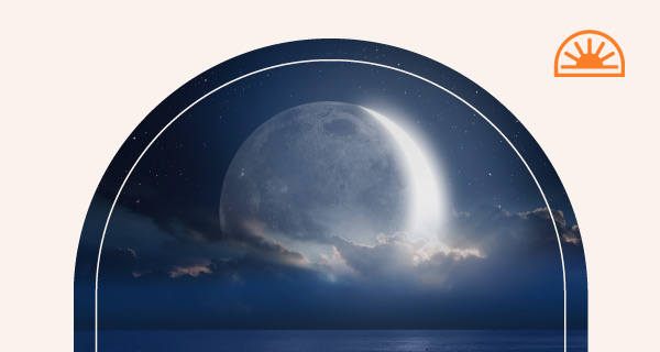 The moon rising on the night sky, symbolizing the lunar return.