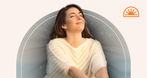 A woman meditating with a gentle black aura emanating from her.