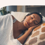 A woman sleeping with her hand under her head.