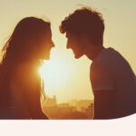 Two people standing in front of a sunset, looking deeply in love