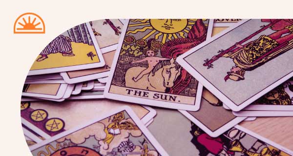 A deck of Tarot cards scattered on someone's desk.
