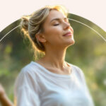 A woman meditating outside.
