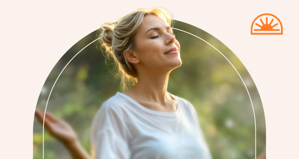 A woman meditating outside.