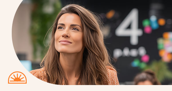 A woman in an office setting, with the number 4 written on a blackboard behind her.