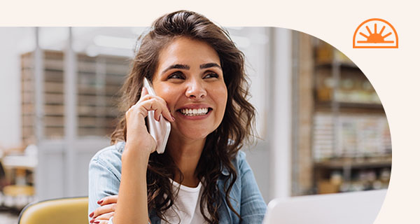 A woman in the office speaking on the phone.