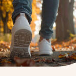 Someone walking through a path in the woods.