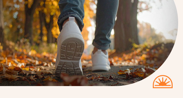 Someone walking through a path in the woods.