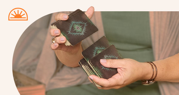 Someone shuffling a deck of Tarot cards