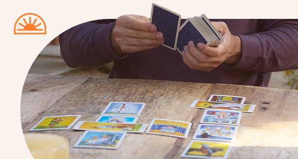 Someone laying a Tarot spread on the table.